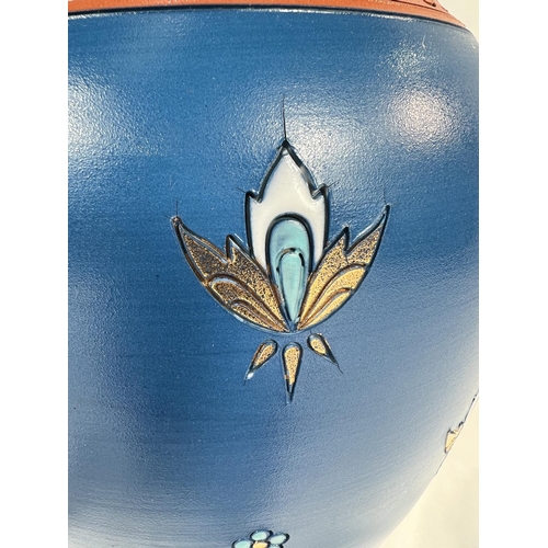 711 - A Mettlach blue ground baluster vase with stylised floral motifs, impressed mark, ht. 23cm