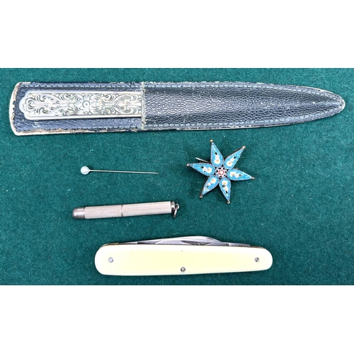 718 - A hallmarked silver retractable tooth pick with engine turned decoration; a star brooch; a white met... 