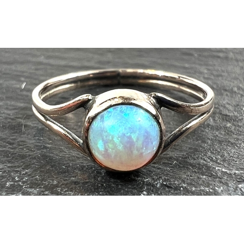 753 - An unmarked dress ring set with an opal, 1 gm, size K (tests as circa 9ct)