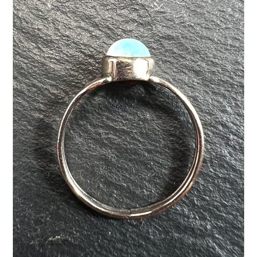 753 - An unmarked dress ring set with an opal, 1 gm, size K (tests as circa 9ct)