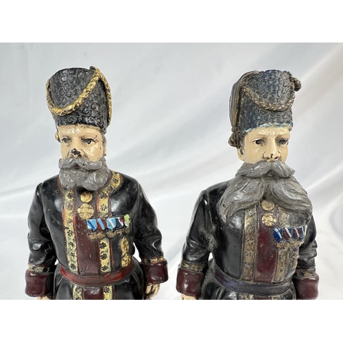 907 - A pair of Russian cold painted bronze figures of bodyguards, signed to feet and dated 1912, ht. 18cm