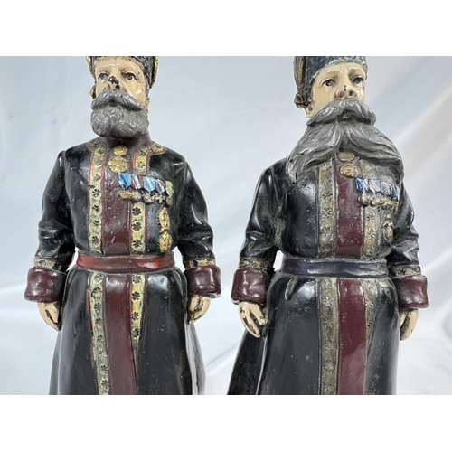 907 - A pair of Russian cold painted bronze figures of bodyguards, signed to feet and dated 1912, ht. 18cm