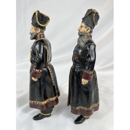 907 - A pair of Russian cold painted bronze figures of bodyguards, signed to feet and dated 1912, ht. 18cm