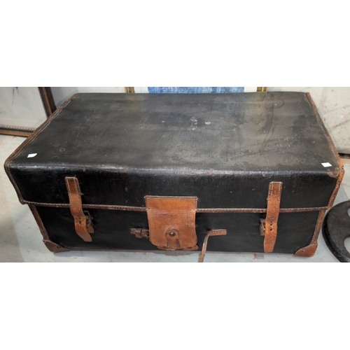 950A - A 19th century Railway trunk with wooden slats on the base black in colour with tan leather bindings