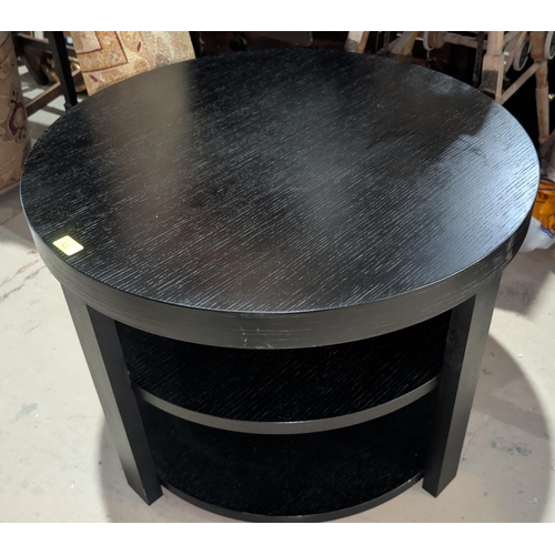 923 - A modern three height black ash coffee table of circular form; a stained wood coffee table and anoth... 