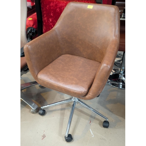 927 - A tan leather swivel office armchair.