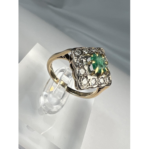 755 - An 18ct hallmarked gold diamond and emerald dress ring, the central emerald square cut and surrounde... 