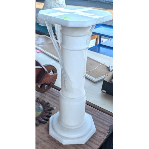 707 - A marble pedestal column with octagonal base and squared top.