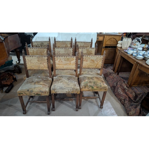 1014 - A set of 12 Medieval style stained wood panel back dining chairs with buttoned needlework upholstery... 