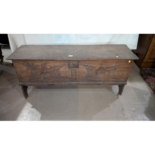 1015 - An early 18th century oak 4 plank chest with original ironwork and incised and carved front panel, l... 