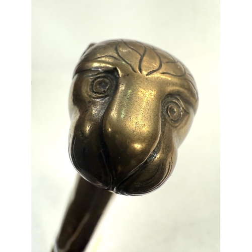 159 - A 19th Century Indian brass sword stick with simulated cane shaft and lion's head finial, 90cm.