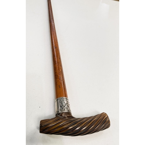 165 - An early 19th Century Malacca cane with silver band and spiral twist carved horn handle, 88cm.