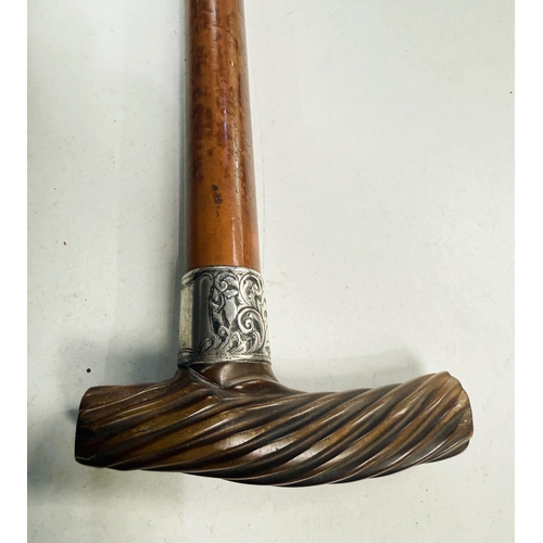 165 - An early 19th Century Malacca cane with silver band and spiral twist carved horn handle, 88cm.