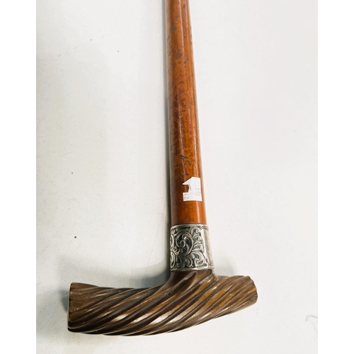 165 - An early 19th Century Malacca cane with silver band and spiral twist carved horn handle, 88cm.