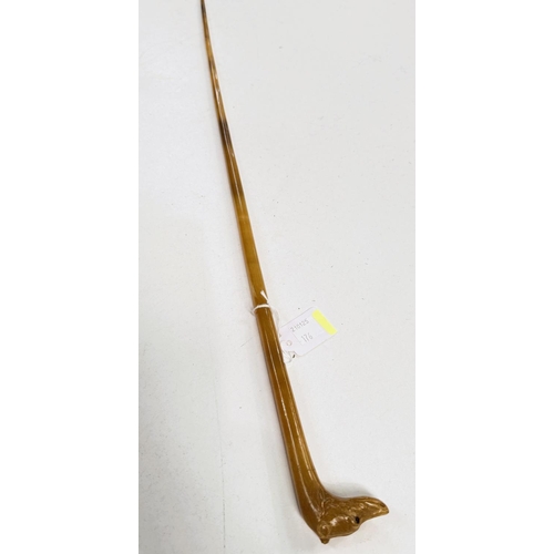 176 - An unusual 19th Century carved horn swagger stick with dog's head finial, 63cm.