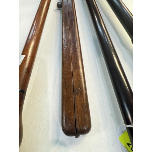 25 - An early 20th Century turned hardwood parade ground stick, 83cms, two similar sticks and a pacing st... 