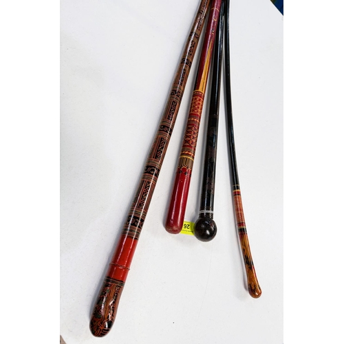 26 - A Japanese black lacquer walking stick with cloisonne decoration, 89cms, and three Indian lacquer st... 