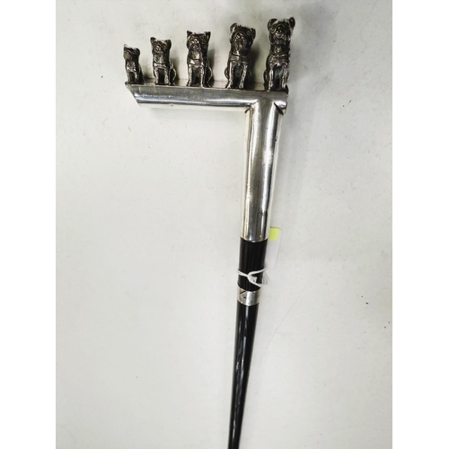 180 - An ebonised walking cane with silver plated handle featuring five puppies of graduating size, 93cm.