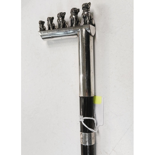 180 - An ebonised walking cane with silver plated handle featuring five puppies of graduating size, 93cm.