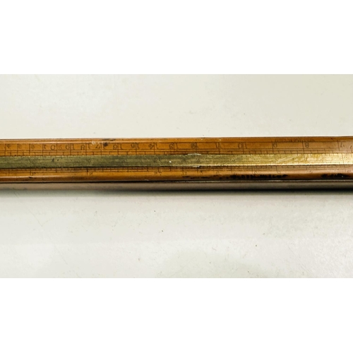 184 - A 19th Century calibrated boxwood staff with measurements for wine etc. with turned handle, 122cm.