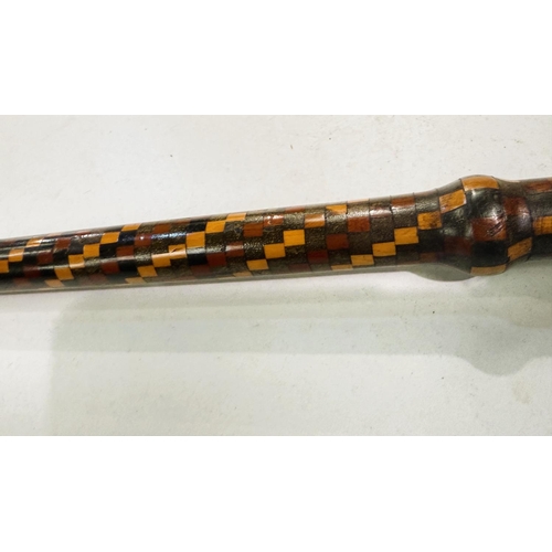 158 - An early 20th Century walking stick with coverall spiral geometric inlaid decoration, 80cm.