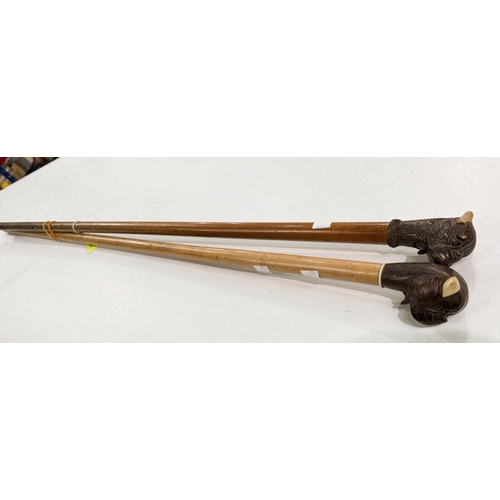 167 - An early 20th Century stick with carved wood finial of a bulldog with 'jaw clicker', 90cm, and anoth... 