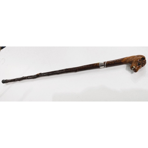 177 - A vintage rustic walking stick with carved head finial of a snaggle-toothed monster, 90cm.