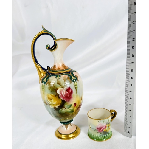 712 - A small Royal Worcester ewer shaped vase decorated with hand painted roses, ht. 18cm and a miniature... 