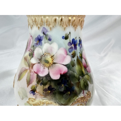 714A - A Royal Worcester covered baluster pot pourri vase on 3 raised paw feet, hand painted with flowers, ... 