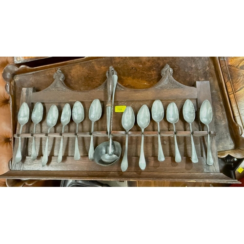 759 - A collection of antique pewter spoons (12) some with monogram stamps etc and a pewter ladle on oak s... 