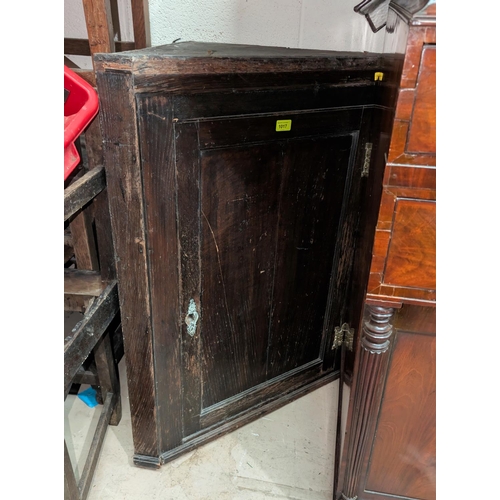 1017 - An 18th century oak straight front corner cupboard with panelled door. [no bids - sold with 1018]