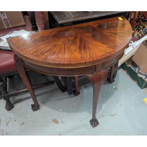 1097 - A mahogany demi-lune card table with quartered crossbanded decoration, inlaid green baize surface an... 