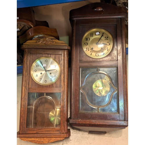 21 - A Warsteiner advertising wall light; two early 20th century striking wall clocks.