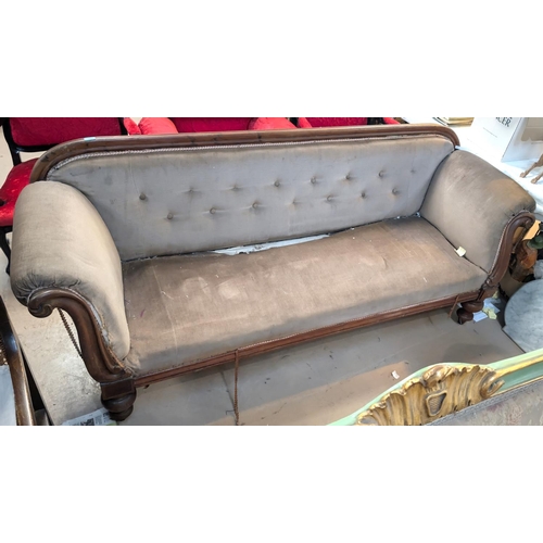 1001 - A Victorian mahogany show frame settee with scrolled ends, turned legs and buttoned fawn dralon (nee... 