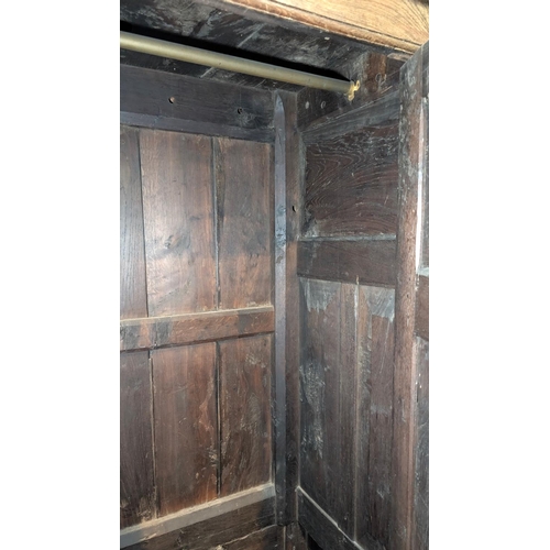 1018 - An 18th century oak full height bacon/housekeepers cupboard with moulded cornice, 2 doors with raise... 