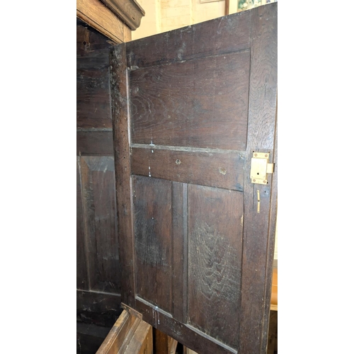 1018 - An 18th century oak full height bacon/housekeepers cupboard with moulded cornice, 2 doors with raise... 