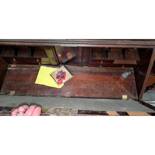 1009 - A Georgian mahogany bookcase with twin glazed doors to the upper section with fall front and inlaid ... 