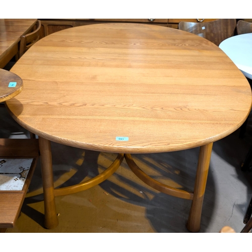 991 - An Ercol Saville light elm and beech dining table of oval form with extending with internal leaf, 16... 