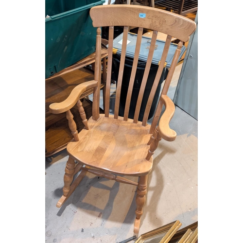 994 - A large lightwood farmhouse rocking chair.