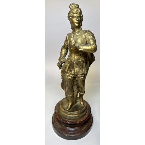 15 - A gilt figure of a man with horn on turned wooden base and a cast iron candle stick in the form of a... 