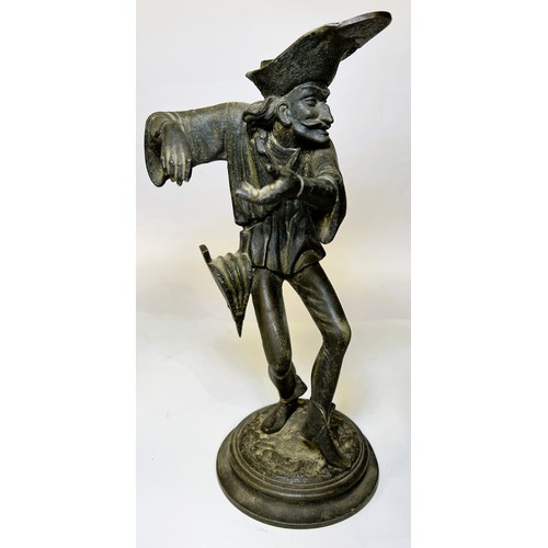 15 - A gilt figure of a man with horn on turned wooden base and a cast iron candle stick in the form of a... 