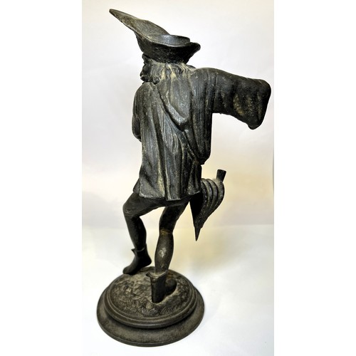 15 - A gilt figure of a man with horn on turned wooden base and a cast iron candle stick in the form of a... 