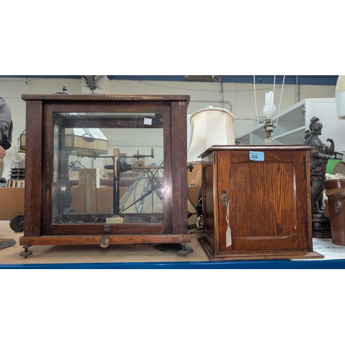 232 - An oak-cased single door smoker's cabinet with ceramic tobacco jar; a pair of laboratory scales in m... 