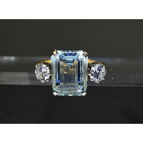 618 - An 18ct gold cushion cut aquamarine coloured stone flanked by two diamonds, approx. 4mm
