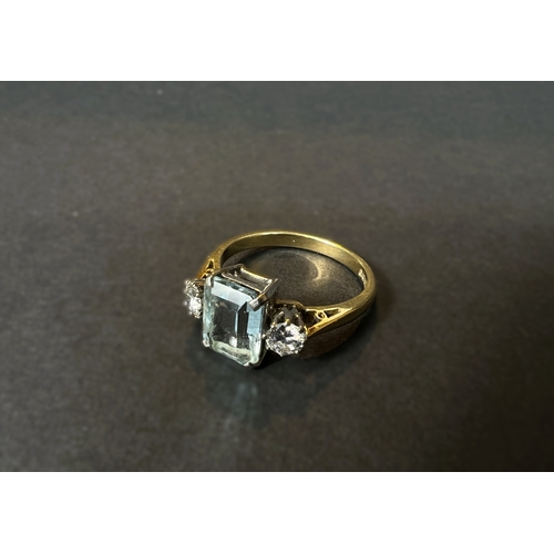 618 - An 18ct gold cushion cut aquamarine coloured stone flanked by two diamonds, approx. 4mm