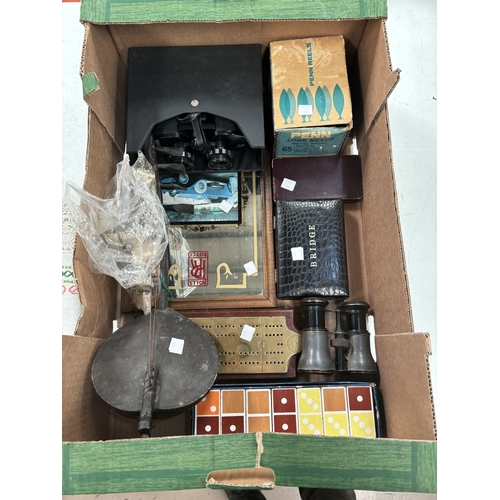 175 - Two pairs of binoculars; a sea fishing reel; a primitive string instrument; games and bric a brac; a... 
