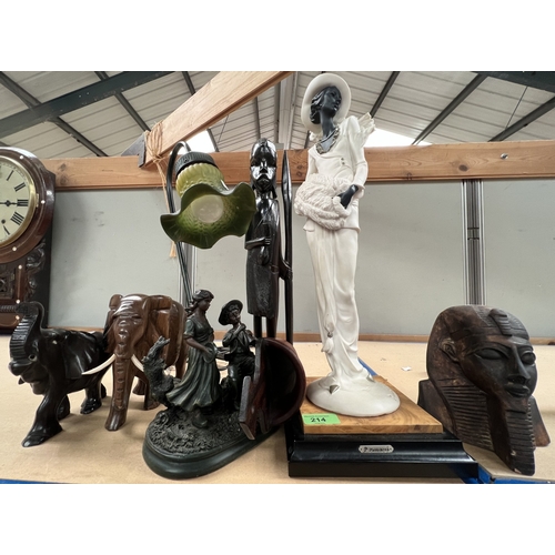 214 - A Florence resin figure of a woman, a bronze effect table lamp in the form of boy and girl, other ca... 