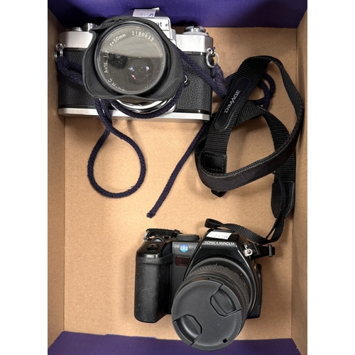 215A - A Nikkormat SLR camera and a Konica Minolta SLR camera.