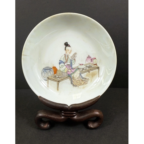 540B - A Chinese shallow dish decorated with central seated and robed figure, reading, turquoise outer rim ... 