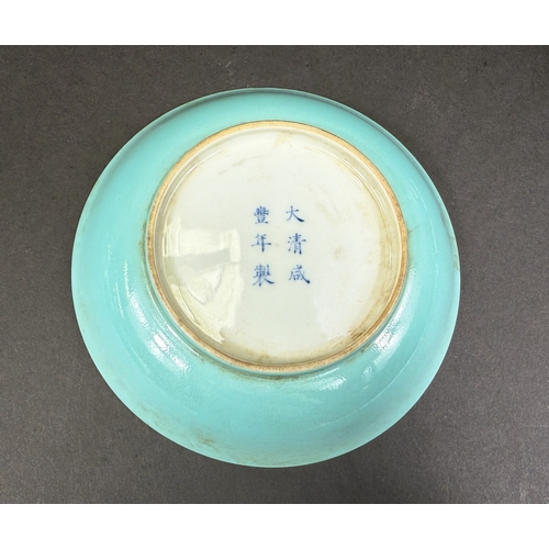 540B - A Chinese shallow dish decorated with central seated and robed figure, reading, turquoise outer rim ... 